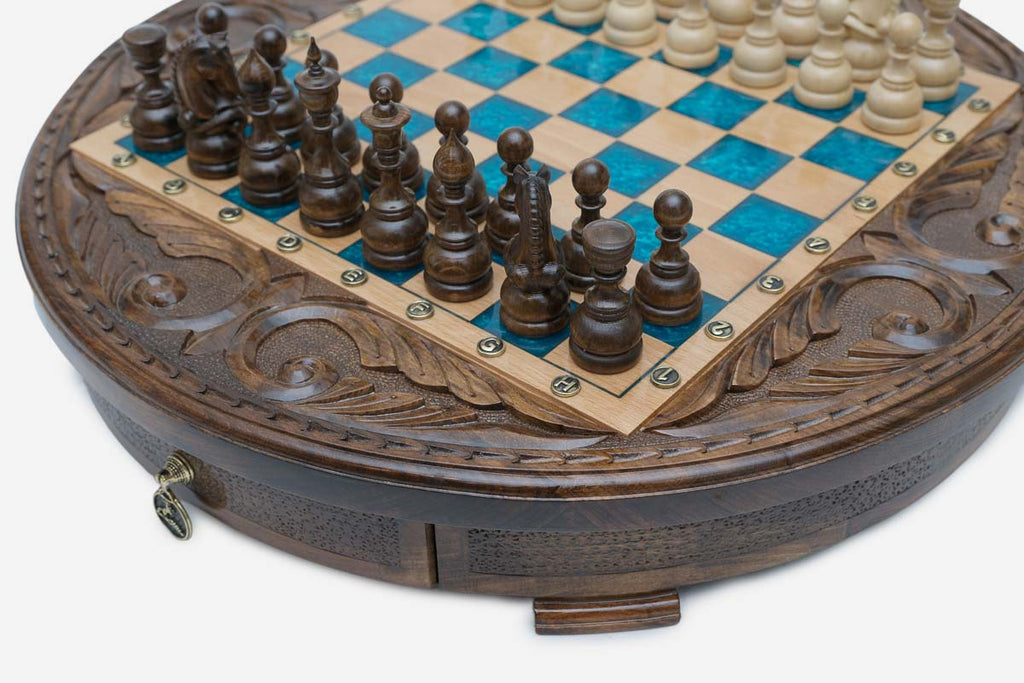 Close-up of the dark wood pieces and turquoise squares with the brass drawer pull below