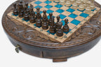Close-up of the dark wood pieces and turquoise squares with the brass drawer pull below