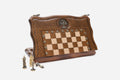 Folding chess backgammon set partly closed, shown with its figural metal pieces and carrying bag