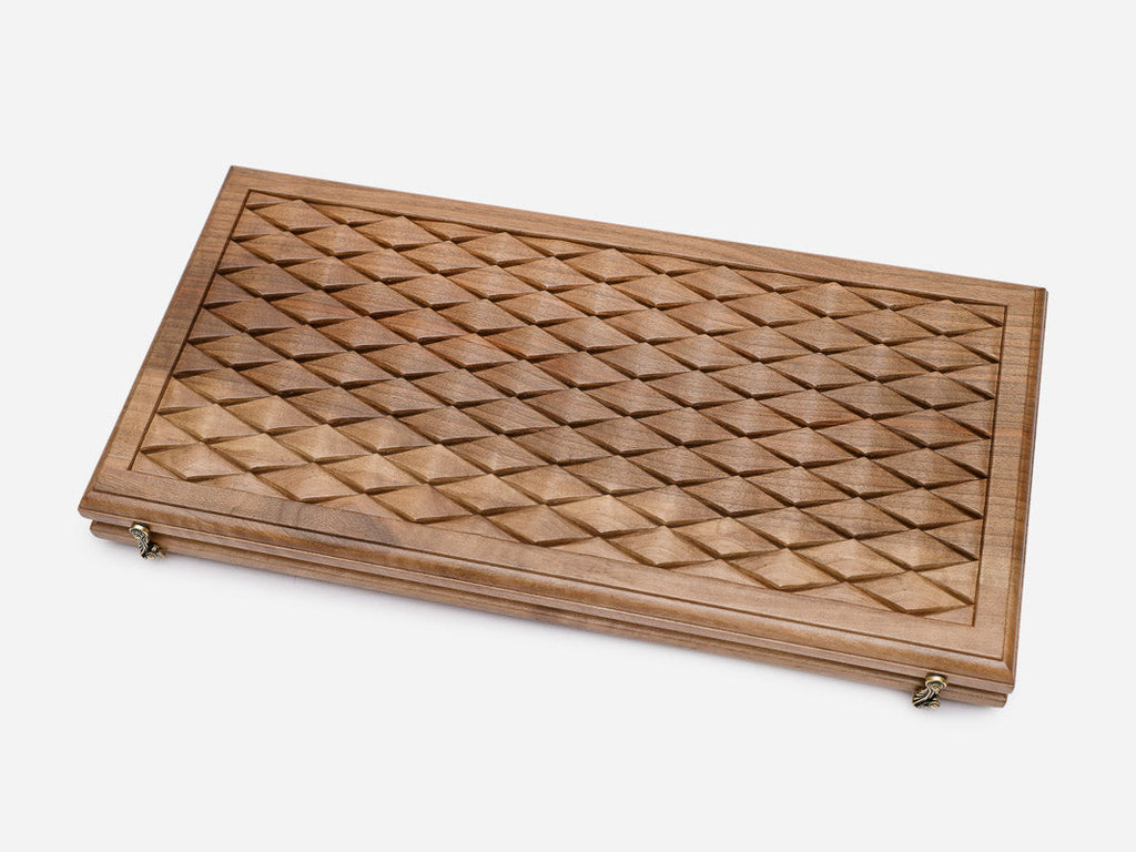Angled view of the luxury walnut backgammon set showing the carved diamonds