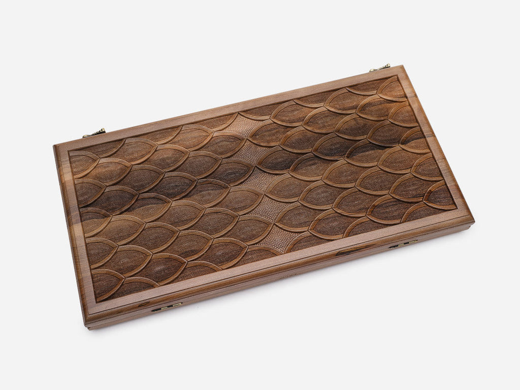 Angled view of the luxury walnut backgammon set showing the carved scales