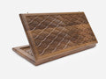 Folding walnut backgammon board with an all-over hand-carved fish-scale relief, shown open