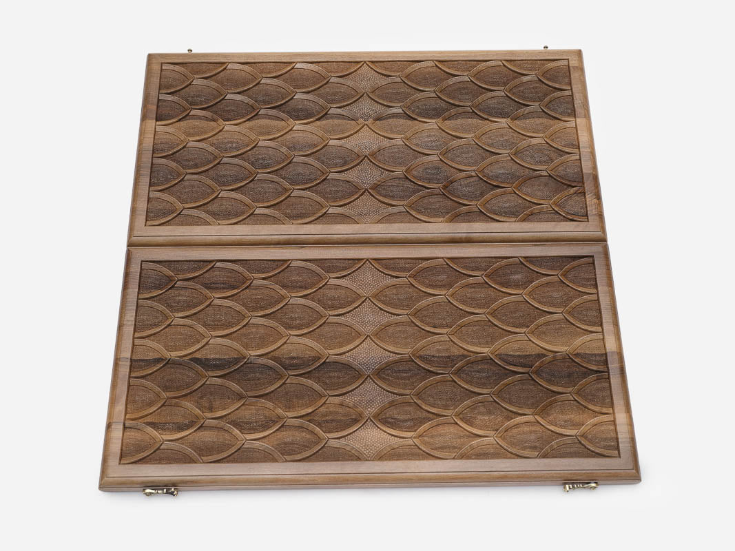 The board half-folded showing both carved faces