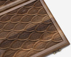 Side view of the folded walnut board showing its bronze hinges