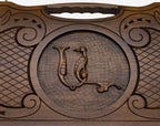 The cut-out carry handle and the upper carving of the lid