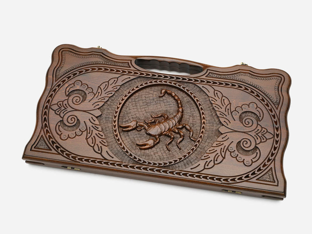 Angled view of the scorpion carved backgammon board
