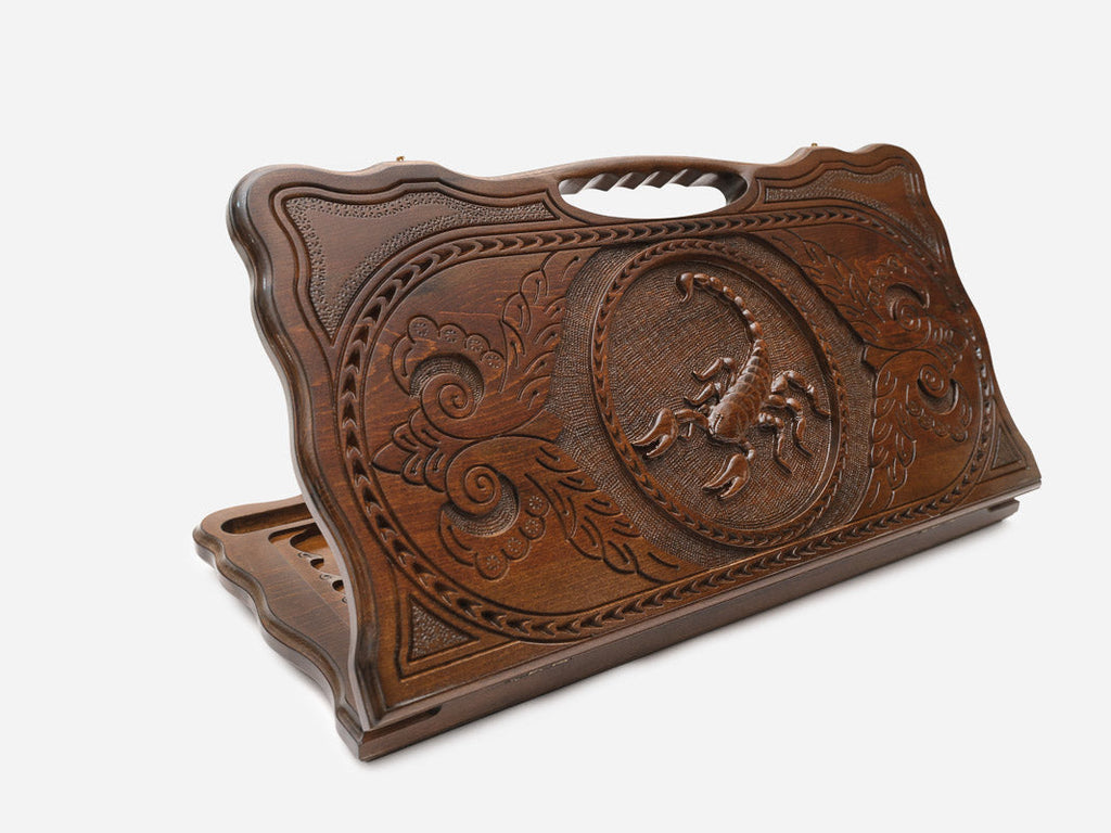 Carved beechwood backgammon board with a scorpion and carry handle, propped open