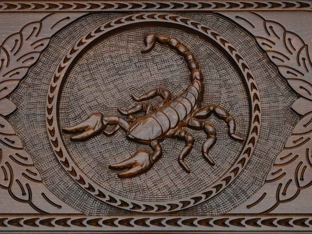 Detail of the scrollwork beside the carved scorpion