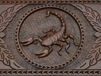 Detail of the scrollwork beside the carved scorpion
