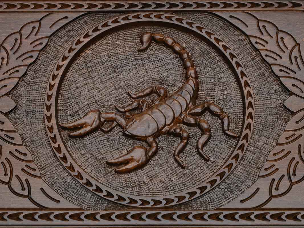 Detail of the scrollwork beside the carved scorpion