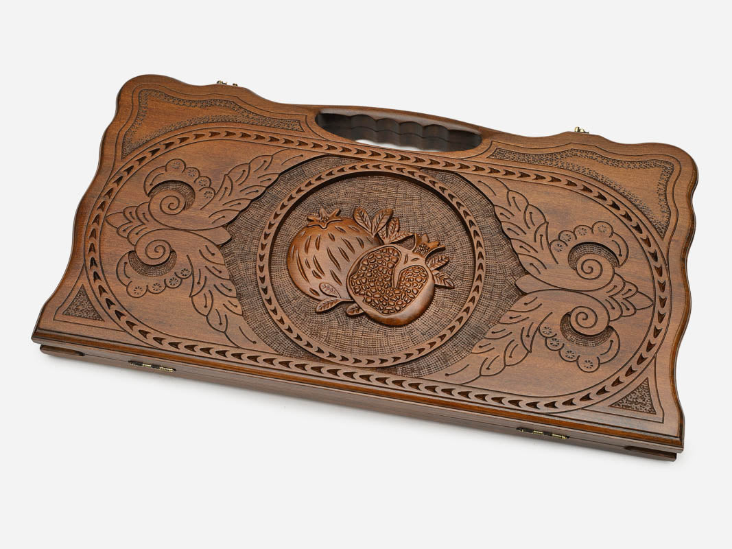 Angled view of the pomegranate carved backgammon board