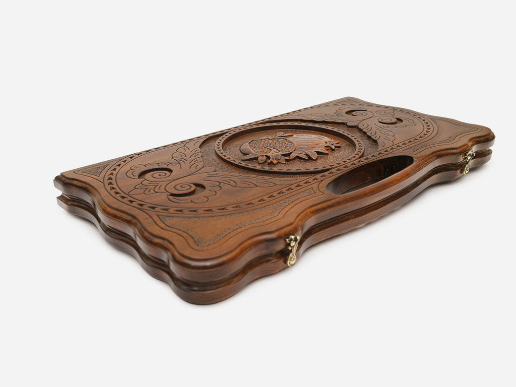 The backgammon board opened to show the wooden playing surface