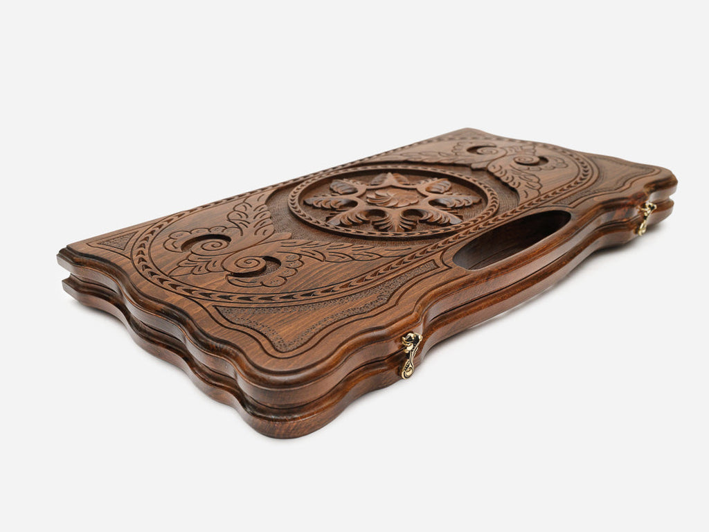 The backgammon board opened to show the wooden playing surface