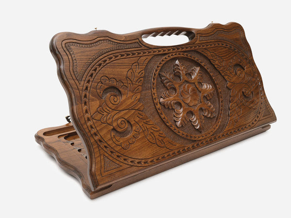 Carved beechwood backgammon board with a snowflake ornament and a carry handle, propped open