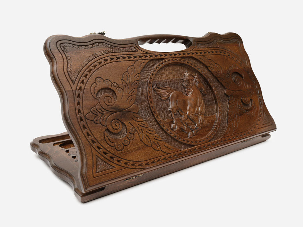 Hand-carved wooden backgammon board with a horse at full gallop and a cut-out carry handle, propped open