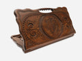 Hand-carved wooden backgammon board with a watchful lynx and a cut-out carry handle, propped open