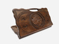 Hand-carved wooden backgammon board with a tiger's head and a cut-out carry handle, propped open