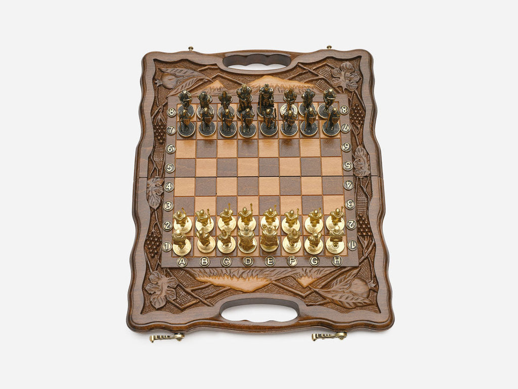 Close-up of gold and silver figural metal chess pieces