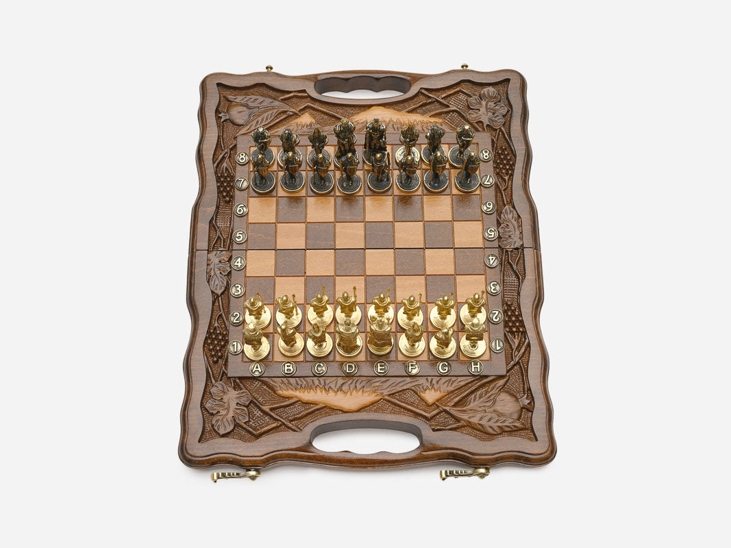 Close-up of gold and silver figural metal chess pieces