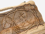 The cut-out carry handle and the upper carving of the lid