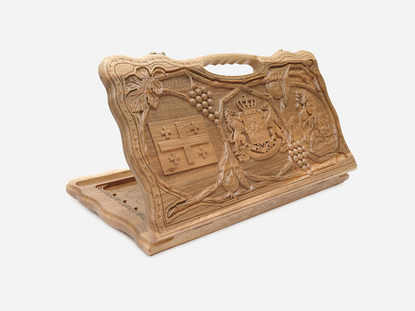 Carved walnut Georgian backgammon board with the coat of arms and cross, cut-out carry handle, propped open