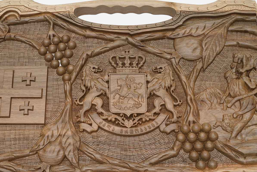 Detail of the carved grapevines wreathing both emblems