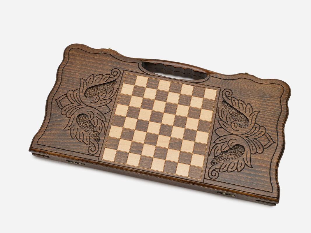 Close-up of the bold ornament carved at the centre of the board