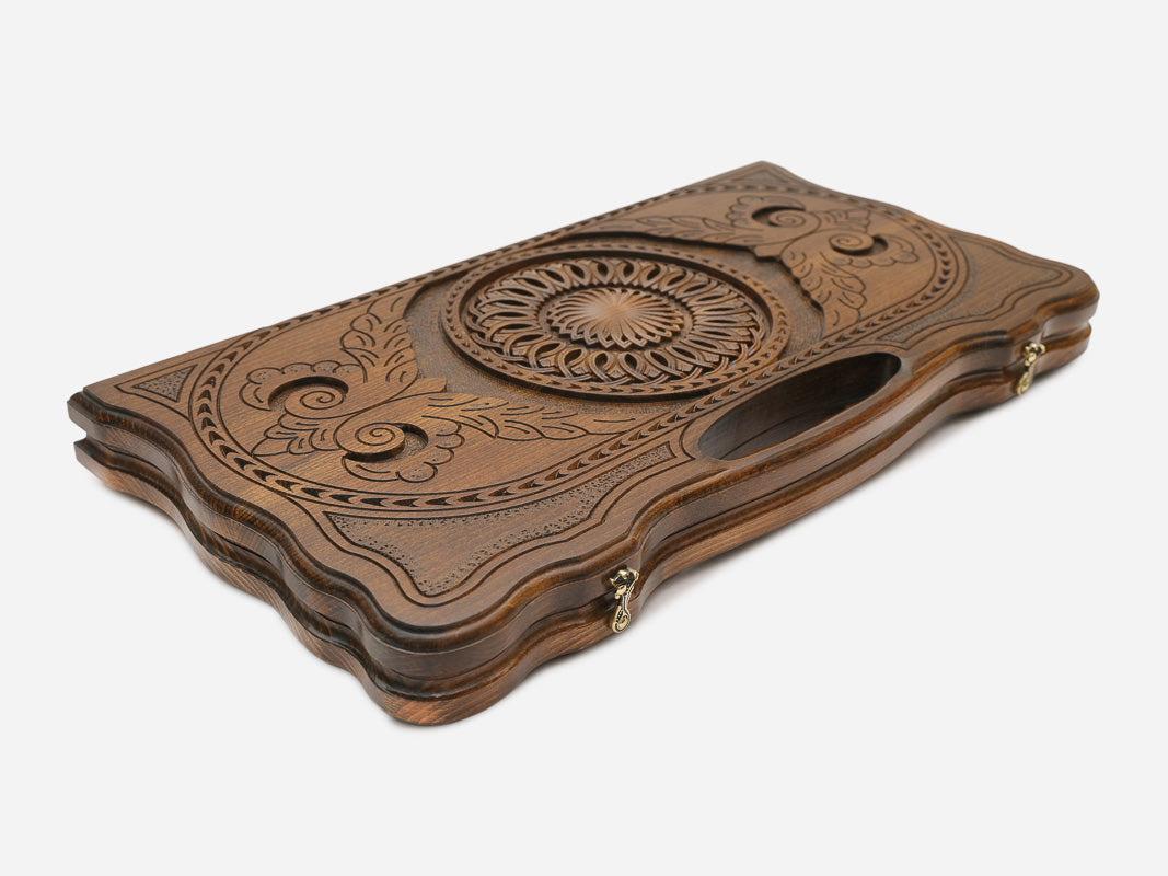 The cut-out carry handle and the braided border carving