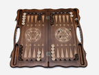Side view of the folded board showing its bronze hinges and clasps