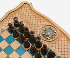 The dark wooden pieces beside the bronze coat of arms inlay