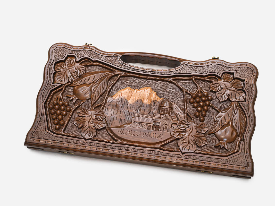 Angled view of the handmade Armenian backgammon set showing the carved scene