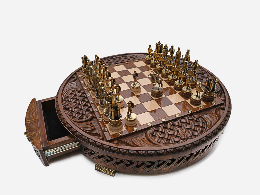 Close-up of the gold-tone king, queen and knight chess pieces on the Royal Circle board