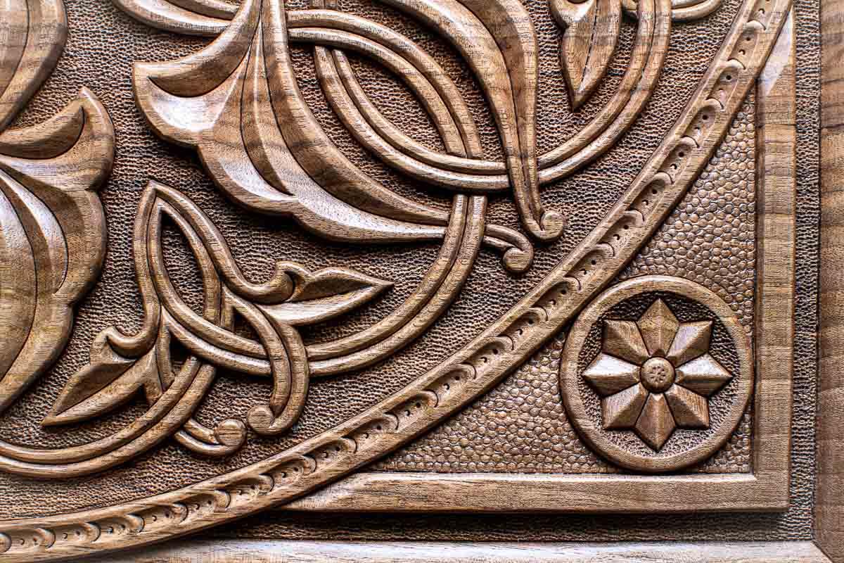 Corner ornament detail on the master-carved walnut board