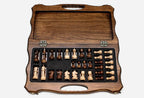 Overhead view of the folding chess board and the full set of 32 pieces