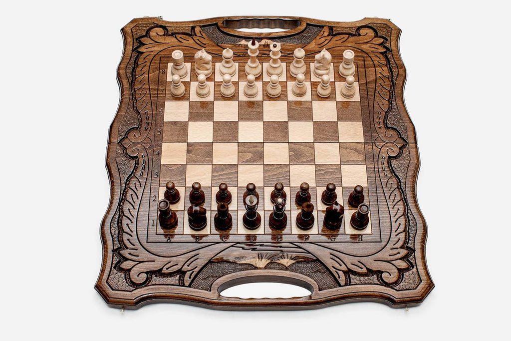Armenian walnut chess set with carved scrollwork borders and a Mount Ararat inlay, pieces in starting position