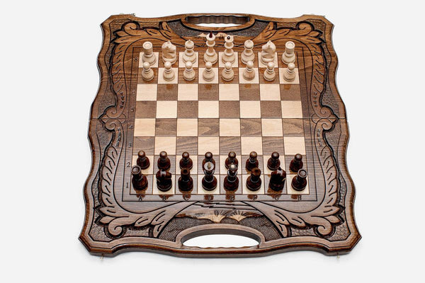 Armenian walnut chess set with carved scrollwork borders and a Mount Ararat inlay, pieces in starting position