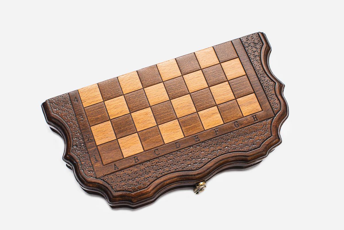 Compact travel chess set shown folded with bronze hinges and clasps