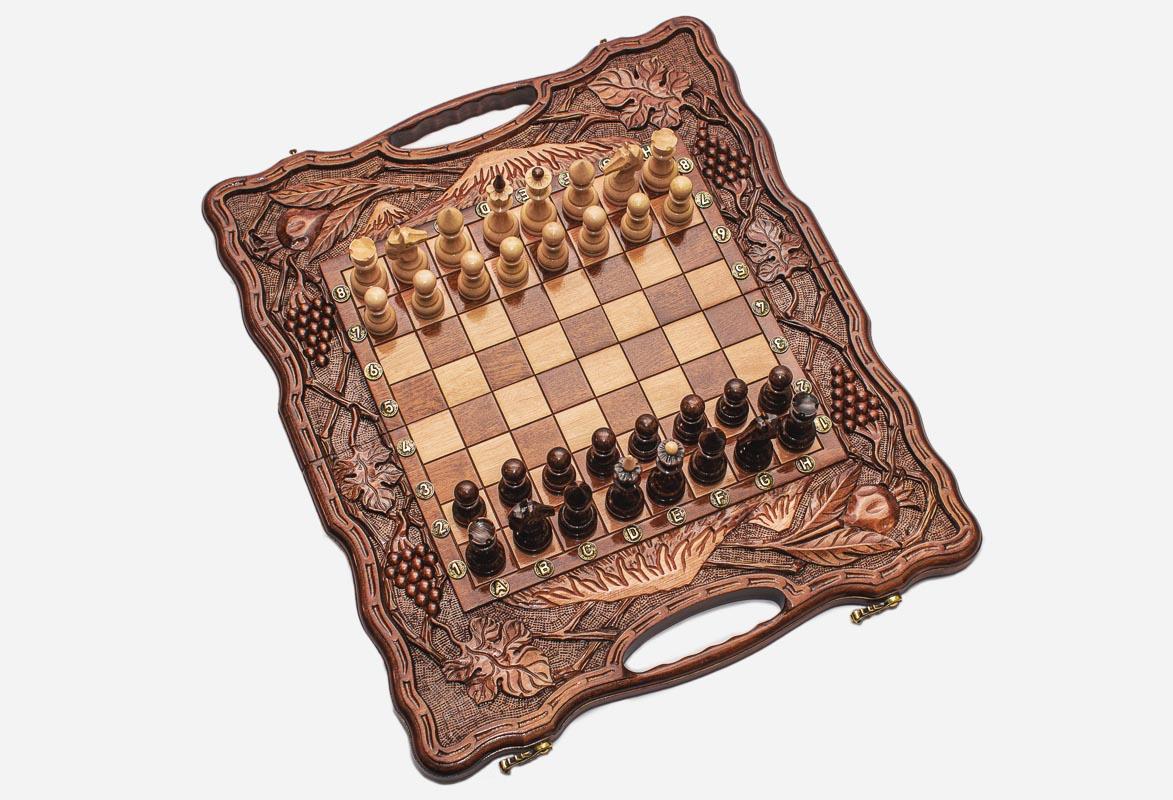 Overhead view of the folding chess board and the full set of 32 pieces