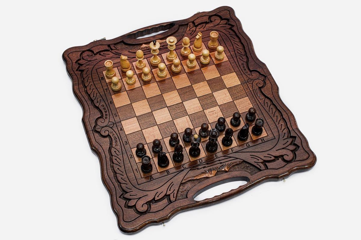 Angled view of the folded walnut chess set with its carved corners