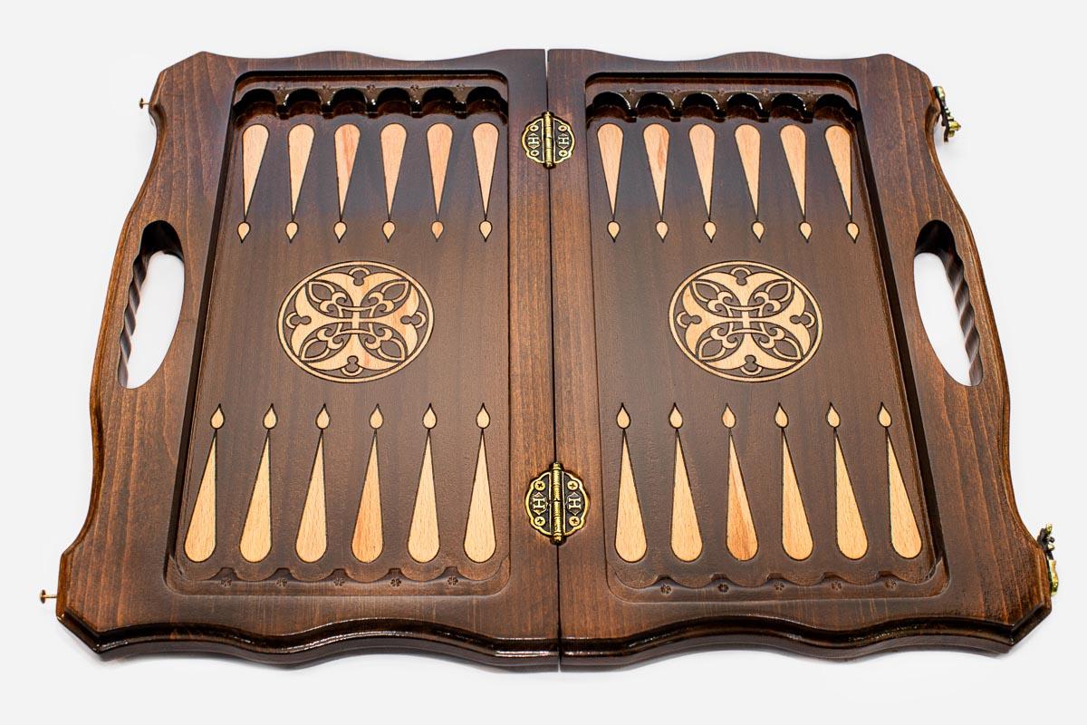 Detail of the deep hand-carved scrollwork running around the walnut border