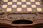 Close-up of the carved border, bronze coordinate markers and built-in carry handle