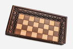 Scrolling floral border hand-carved on a wooden chess board - detail