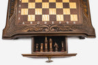 Close-up of the compact chess set's front storage drawer open, showing the dark chess pieces