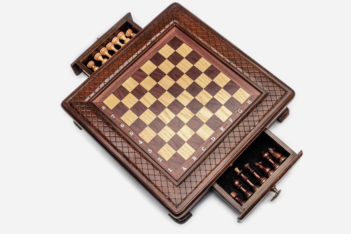 Compact chess set with both side drawers pulled out showing the light and dark pieces stored inside