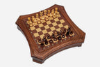 Angled top view of the curved-side chess board with light and dark pieces arranged for play