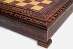 Chess pieces stored in the felt-lined interior of the hinged wooden case