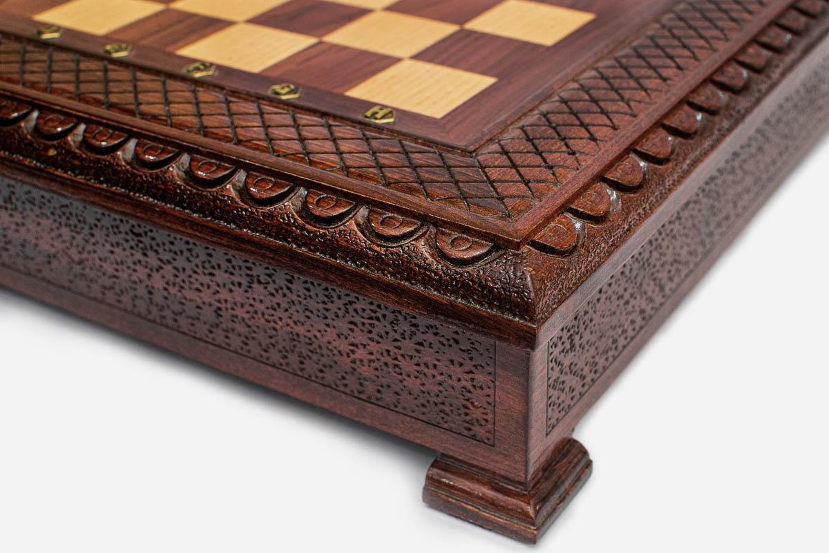 Chess pieces stored in the felt-lined interior of the hinged wooden case