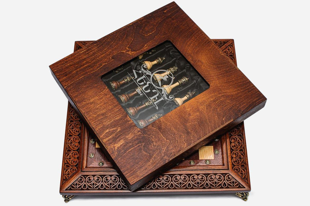 Wooden presentation box with viewing window covering the satin-wrapped chess pieces