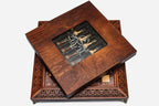 Wooden presentation box with viewing window covering the satin-wrapped chess pieces