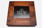 Wooden gift box lid with engraved maker's emblem and viewing window
